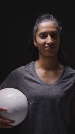 Vertical-Video-Studio-Portrait-Of-Woman-Wearing-Sports-Clothing-Against-Dark-Background